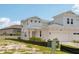 Charming townhome features a two-car garage and neutral color scheme with simple landscaping at 31857 Anchor Point Dr, Wesley Chapel, FL 33545