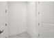 Hallway with two doors, tile floor, and white walls at 31857 Anchor Point Dr, Wesley Chapel, FL 33545