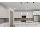 Modern kitchen featuring stainless steel appliances, gray backsplash, and bright lighting at 31857 Anchor Point Dr, Wesley Chapel, FL 33545