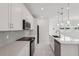 Modern kitchen with stainless steel appliances, island with sink, and designer lighting at 31857 Anchor Point Dr, Wesley Chapel, FL 33545