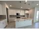 Modern kitchen featuring white cabinets, quartz countertops, stainless steel appliances, and pendant lighting at 31857 Anchor Point Dr, Wesley Chapel, FL 33545