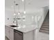 Open-concept kitchen with island and eat-in bar. Modern fixtures and finishes throughout at 31857 Anchor Point Dr, Wesley Chapel, FL 33545