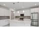 Stylish kitchen with stainless steel appliances, gray backsplash, and white cabinetry at 31857 Anchor Point Dr, Wesley Chapel, FL 33545