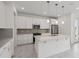 Bright kitchen featuring an island with counter seating, modern appliances, and stylish pendant lighting at 31857 Anchor Point Dr, Wesley Chapel, FL 33545
