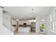 Open floorplan features a living area and kitchen with marble floors and lots of natural light at 31857 Anchor Point Dr, Wesley Chapel, FL 33545