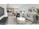 Virtually staged living room features a modern design with open floor plan to the kitchen and dining areas at 31857 Anchor Point Dr, Wesley Chapel, FL 33545