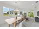 Virtually staged living and dining area with a large table, stylish furniture, and natural light at 31857 Anchor Point Dr, Wesley Chapel, FL 33545