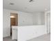 Upstairs loft area with staircase and door leading to bathroom at 31857 Anchor Point Dr, Wesley Chapel, FL 33545