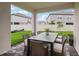 Outdoor dining is showcased on this covered patio overlooking the neighborhood at 31857 Anchor Point Dr, Wesley Chapel, FL 33545