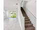 View of the white staircase with carpeted steps leading to the upper level at 31857 Anchor Point Dr, Wesley Chapel, FL 33545