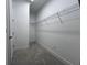 Spacious walk-in closet providing ample storage space with wire shelving and neutral carpeting at 31857 Anchor Point Dr, Wesley Chapel, FL 33545