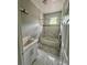 Bathroom features a tiled shower-tub combo, modern vanity with sink, and gray tiled flooring at 3413 N 72Nd St, Tampa, FL 33619