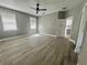 Bright bedroom features two windows, light gray walls, wood-look flooring, and a modern ceiling fan at 3413 N 72Nd St, Tampa, FL 33619