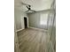 Bedroom features a ceiling fan, light gray walls, wood-look flooring, closet, and natural light at 3413 N 72Nd St, Tampa, FL 33619
