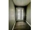 Entryway with stylish wood-look flooring and a white door with glass insets letting in ample natural light at 3413 N 72Nd St, Tampa, FL 33619