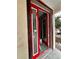 Close up of a new construction home's red-framed front door, viewed from the exterior at 3413 N 72Nd St, Tampa, FL 33619