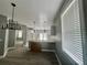 Open concept kitchen with stainless steel appliances, white cabinetry, wood-look floors and bar seating at 3413 N 72Nd St, Tampa, FL 33619