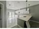 Stylish kitchen with marble countertops, white cabinets, open design, and elegant marble flooring at 3413 N 72Nd St, Tampa, FL 33619