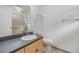 Bright bathroom featuring a large mirror, vanity with storage, and a shower with sliding glass doors at 37838 Granada Ave, Zephyrhills, FL 33541