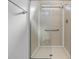 Bathroom shower equipped with grab bars and clear glass doors, providing accessibility and safety at 37838 Granada Ave, Zephyrhills, FL 33541