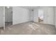 Spacious bedroom featuring neutral walls and plush carpeting, leading to a walk-in closet and private bathroom at 37838 Granada Ave, Zephyrhills, FL 33541