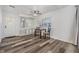 Well-lit dining space featuring stylish floors, a ceiling fan, and built-in storage at 37838 Granada Ave, Zephyrhills, FL 33541