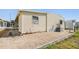 Exterior view with low-maintenance landscaping, utility access and side yard at 37838 Granada Ave, Zephyrhills, FL 33541