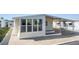 Cozy home featuring low-maintenance landscaping, a carport and an enclosed porch for relaxing at 37838 Granada Ave, Zephyrhills, FL 33541