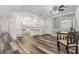 Open-concept living area with modern flooring seamlessly flowing into a well-equipped kitchen at 37838 Granada Ave, Zephyrhills, FL 33541