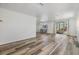 Spacious living room with modern floors, and sliding glass doors to screened patio at 37838 Granada Ave, Zephyrhills, FL 33541