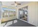 Enclosed patio with lots of light, ceiling fan and entrance to the living area at 37838 Granada Ave, Zephyrhills, FL 33541