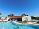 Community pool and clubhouse with lounge chairs under a bright sky, perfect for relaxation at 37838 Granada Ave, Zephyrhills, FL 33541
