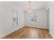 Elegant dining room featuring crown molding, wainscoting, wood floors, shuttered windows and a crystal chandelier at 3807 W San Pedro St, Tampa, FL 33629