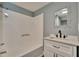Updated bathroom with white vanity, modern fixtures, and tub with showerhead at 39809 Pretty Pond Rd, Zephyrhills, FL 33540