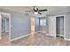 This spacious bedroom features a ceiling fan, closet, and gray wood flooring at 39809 Pretty Pond Rd, Zephyrhills, FL 33540