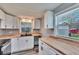 Bright kitchen features white cabinets, butcher block countertops, undermount sink, and stainless steel appliances at 39809 Pretty Pond Rd, Zephyrhills, FL 33540