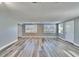 Spacious, bright living room with vinyl plank flooring, ample natural light, and multiple entryways at 39809 Pretty Pond Rd, Zephyrhills, FL 33540