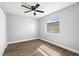 Light and airy bedroom features wood-look laminate flooring, new windows, and neutral colored walls at 6401 Elmhurst Ct, Pinellas Park, FL 33782