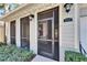 Inviting entryway with a screened door and well-manicured landscaping at 6906 Muncaster Ct, Tampa, FL 33625