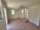 Living room with tile flooring, ceiling fan, and natural light at 6935 W Mohawk Ave, Tampa, FL 33634