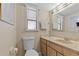 Cozy bathroom featuring a single sink vanity, framed mirror, and a window for natural light at 720 Gasparino Ct, Seffner, FL 33584