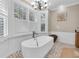 Bathroom featuring a soaking tub, neutral paint, and a chandelier at 732 Oak Ne St, St Petersburg, FL 33701