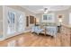 Comfortable primary bedroom featuring hardwood floors, french door access, a ceiling fan, and white plantation shutters at 732 Oak Ne St, St Petersburg, FL 33701