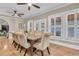 Formal dining room featuring a glass-top dining table, seating for eight, light wood flooring and shuttered windows at 732 Oak Ne St, St Petersburg, FL 33701
