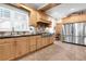 A fully equipped kitchen features stainless steel appliances, abundant wood cabinetry, tile backsplash, and tile flooring at 732 Oak Ne St, St Petersburg, FL 33701