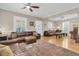 Spacious living room featuring hardwood floors, large windows, ceiling fans, and comfortable seating at 732 Oak Ne St, St Petersburg, FL 33701