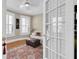 Cozy living room with a large rug, sofa, and ottoman, flooded with natural light from shuttered windows at 732 Oak Ne St, St Petersburg, FL 33701