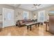 An elegant living space featuring hardwood floors, large windows, ceiling fans, and classic furnishings at 732 Oak Ne St, St Petersburg, FL 33701
