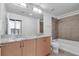 Modern bathroom features double sinks, granite countertops, bathtub, shower, and bright lighting at 777 N Ashley Dr # 1915, Tampa, FL 33602