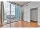 A bedroom with a large window offering city views and a walk-in closet for storage at 777 N Ashley Dr # 1915, Tampa, FL 33602